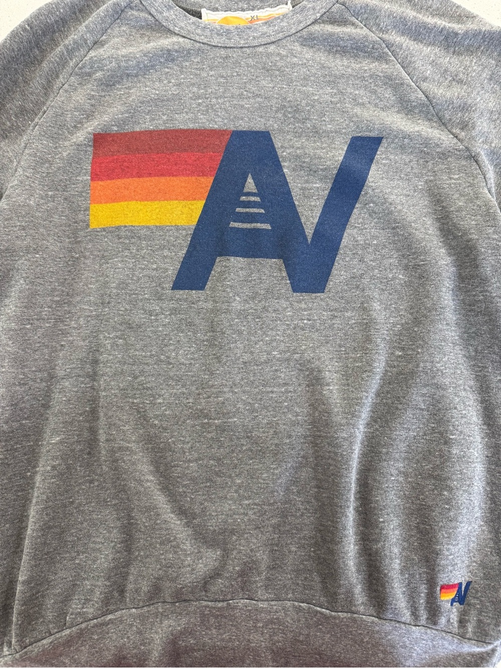 Aviator Nation Gray Crewneck with Blue AV Logo and Red-Orange-Yellow Stripe